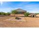 Backyard with fire pit and dog house, desert landscape at 1623 E Hidalgo St, Apache Junction, AZ 85119
