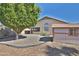 Landscaped backyard with gravel, mature tree, and storage shed at 17124 N Melissa Ln, Surprise, AZ 85374