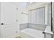 Clean bathroom with a bathtub, window, and modern tile at 17124 N Melissa Ln, Surprise, AZ 85374