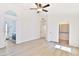 Bright bedroom with wood-look flooring and access to a bathroom at 17124 N Melissa Ln, Surprise, AZ 85374