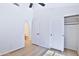 Well-lit bedroom, with wood-look floors and two closets at 17124 N Melissa Ln, Surprise, AZ 85374