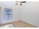 Light and airy bedroom featuring wood-look floors and a window with blinds at 17124 N Melissa Ln, Surprise, AZ 85374