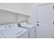 Laundry room with washer, dryer, and overhead shelving at 17124 N Melissa Ln, Surprise, AZ 85374