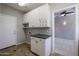 Laundry room with white cabinets and granite countertops at 1737 E Carob Dr, Chandler, AZ 85286