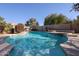 Relaxing kidney-shaped pool with stone accents at 1737 E Carob Dr, Chandler, AZ 85286