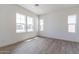 Bright and airy home office featuring wood-look floors and ample natural light at 17394 W Sugar Hill Ct, Surprise, AZ 85388