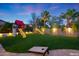 Landscaped backyard with playset and artificial turf at 17962 W Montecito Ave, Goodyear, AZ 85395