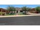 Two-story house with landscaping, driveway, and a metal gate at 17962 W Montecito Ave, Goodyear, AZ 85395