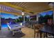 Entertainment area with pool table, outdoor kitchen, and TV at 17962 W Montecito Ave, Goodyear, AZ 85395