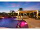 Expansive pool with waterfall feature and illuminated seating at 17962 W Montecito Ave, Goodyear, AZ 85395