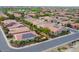 Aerial image showing a neighborhood with houses and solar panels at 1806 E Azafran Trl, Queen Creek, AZ 85140