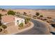 Aerial view of a house with a two-car garage and desert landscaping at 1806 E Azafran Trl, Queen Creek, AZ 85140