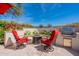Outdoor patio with seating area, fire pit, and built-in grill at 1806 E Azafran Trl, Queen Creek, AZ 85140