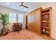 Bedroom features a built-in Murphy bed, wood shelving and window seat at 1806 E Azafran Trl, Queen Creek, AZ 85140