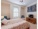 Bedroom with arched window, ceiling fan and media console at 1806 E Azafran Trl, Queen Creek, AZ 85140