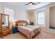 Bedroom with arched window, ceiling fan and window seat at 1806 E Azafran Trl, Queen Creek, AZ 85140