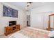 Bedroom with double door closet and media console at 1806 E Azafran Trl, Queen Creek, AZ 85140