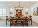 Formal dining room featuring a rustic wooden table and chandelier at 1806 E Azafran Trl, Queen Creek, AZ 85140