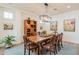 Formal dining room with a rustic wooden table and chandelier at 1806 E Azafran Trl, Queen Creek, AZ 85140
