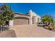 Home exterior with two-car garage and desert landscaping at 1806 E Azafran Trl, Queen Creek, AZ 85140