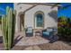 Front patio with seating area and desert plants at 1806 E Azafran Trl, Queen Creek, AZ 85140