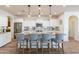 Island kitchen with granite countertops, stainless steel appliances, and white cabinets at 1806 E Azafran Trl, Queen Creek, AZ 85140