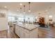 Open concept kitchen and dining area with large granite island at 1806 E Azafran Trl, Queen Creek, AZ 85140