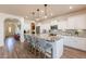 Open kitchen with granite island and hardwood floors at 1806 E Azafran Trl, Queen Creek, AZ 85140