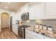 Modern kitchen with granite countertops and white cabinets at 1806 E Azafran Trl, Queen Creek, AZ 85140