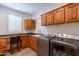 Laundry room with built-in cabinets and shelving at 1806 E Azafran Trl, Queen Creek, AZ 85140