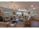 Bright living room with hardwood floors, comfy seating, and sliding glass doors leading to a patio at 1806 E Azafran Trl, Queen Creek, AZ 85140