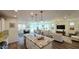 Open-concept living space with hardwood floors, granite island, and views to the outside dining and living area at 1806 E Azafran Trl, Queen Creek, AZ 85140