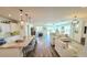 Bright, open-concept living space featuring modern lighting, hardwood floors, and a spacious granite island at 1806 E Azafran Trl, Queen Creek, AZ 85140