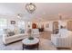 Bright living room with comfortable seating and a large TV at 1806 E Azafran Trl, Queen Creek, AZ 85140