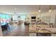 Bright open concept living space with hardwood floors, white walls, and large windows at 1806 E Azafran Trl, Queen Creek, AZ 85140