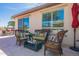 Wicker patio furniture with colorful cushions creates a cozy seating area at 1806 E Azafran Trl, Queen Creek, AZ 85140