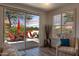 View of a patio with seating and a red umbrella through sliding glass doors at 1806 E Azafran Trl, Queen Creek, AZ 85140