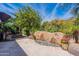 Stone water feature with colorful planters adding charm to the backyard at 1806 E Azafran Trl, Queen Creek, AZ 85140