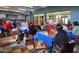 Bright community art room with multiple residents painting at 18116 W Silverwood Dr, Goodyear, AZ 85338