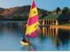 Sailboat on a lake with a clubhouse in the background at 18116 W Silverwood Dr, Goodyear, AZ 85338