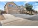 Two-story house with a three-car garage and landscaped front yard at 18437 W Sunnyslope Ln, Waddell, AZ 85355