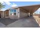 Mobile home with covered carport and gravel driveway at 205 S Higley Rd # 4, Mesa, AZ 85206