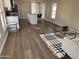 Bright open floorplan with updated kitchen, wood floors, and view to a modern living room at 205 S Higley Rd # 4, Mesa, AZ 85206