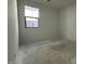 A sunlit bedroom boasts ample space and a clear window view at 22836 E Lords Way, Queen Creek, AZ 85142