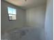 An empty bedroom with freshly painted walls and a single window for natural light at 22836 E Lords Way, Queen Creek, AZ 85142