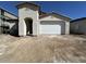 Home exterior shows a two car garage, desert landscaping, and a modern design at 22836 E Lords Way, Queen Creek, AZ 85142
