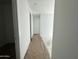 Neutral hallway with tile floor and white door at 22836 E Lords Way, Queen Creek, AZ 85142