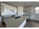 Bright kitchen featuring white cabinets, stainless sink, and stone countertops at 22836 E Lords Way, Queen Creek, AZ 85142