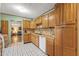 Kitchen with wood cabinets and view into adjacent living room at 232 E Colter St, Phoenix, AZ 85012