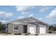 Two-story home with gray exterior, white trim, and a two-car garage at 2690 E Abe Truckle Ave, San Tan Valley, AZ 85140